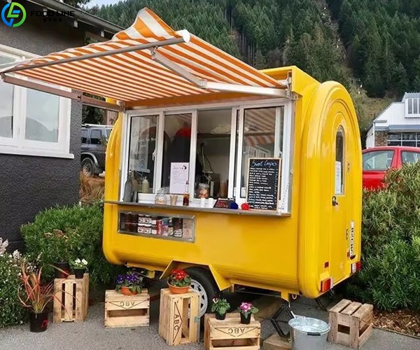 yellow round coffee trailer